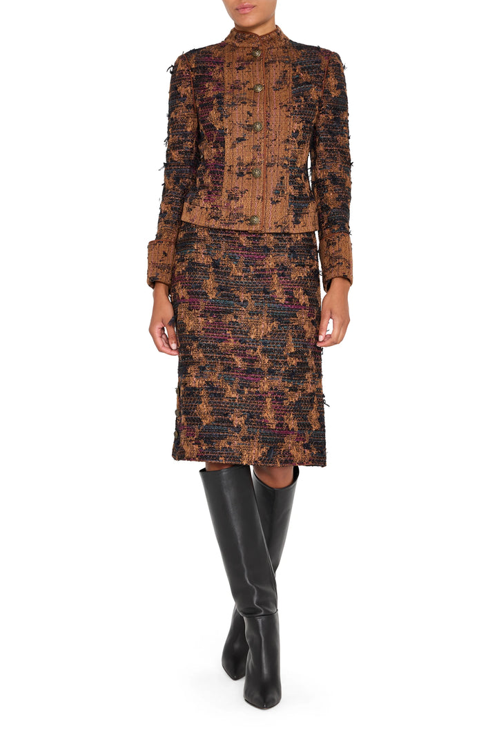 Tailored tweed jacket with structured silhouette, classic lapels, and flap pockets; front view on white.