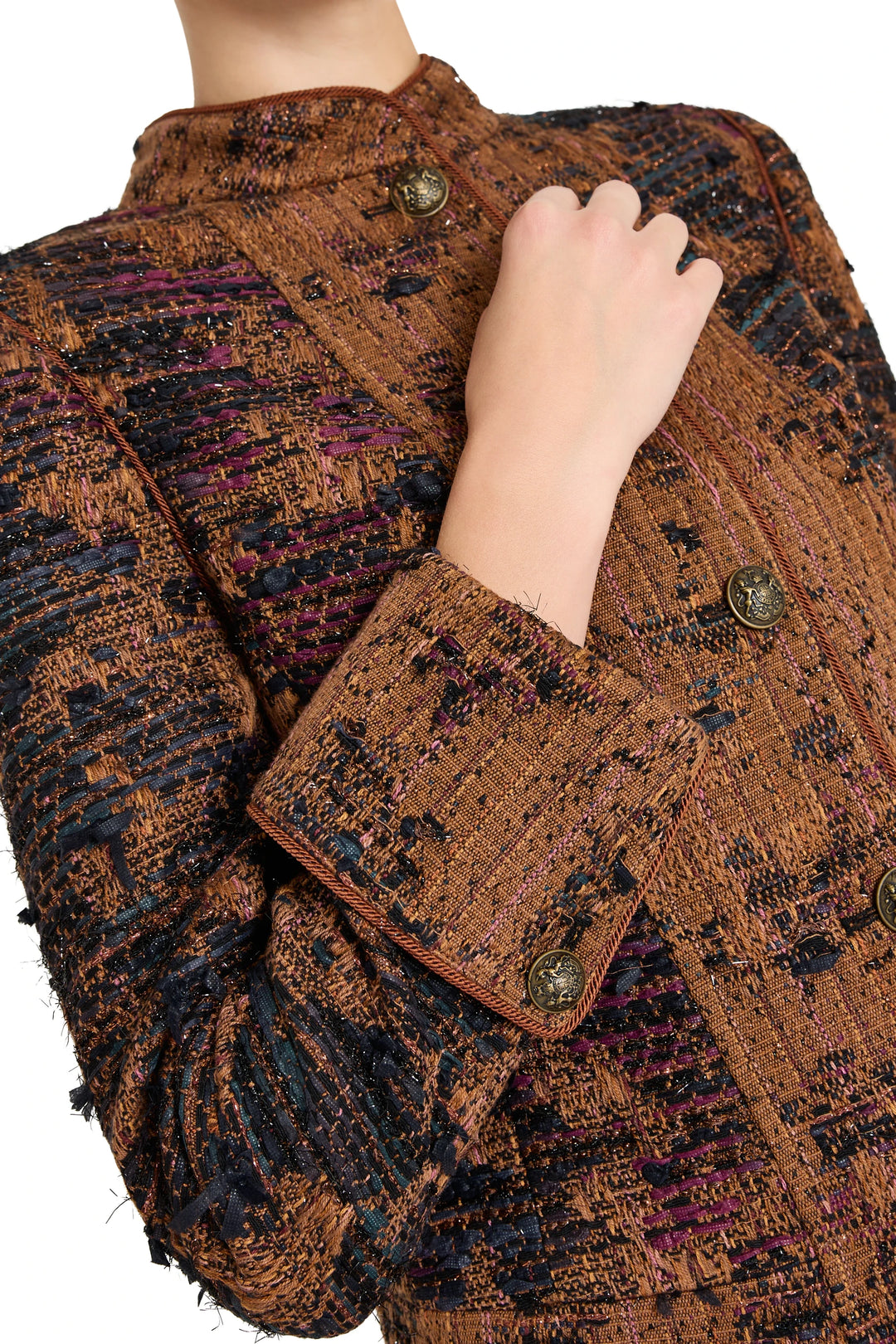 Detail of Parker Tweed Jacket with metallic buttons, structured collar and textured tweed fabric; detail view.