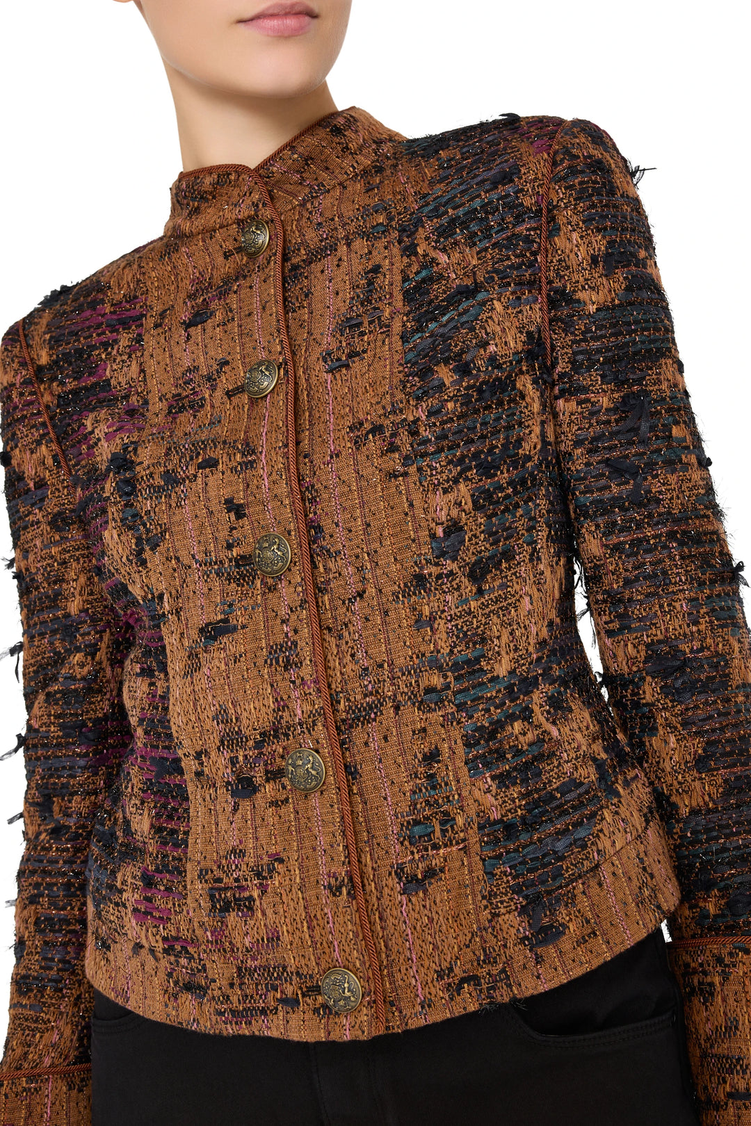 Structured tweed jacket with high collar, military tailoring, decorative buttons. Front view on white.