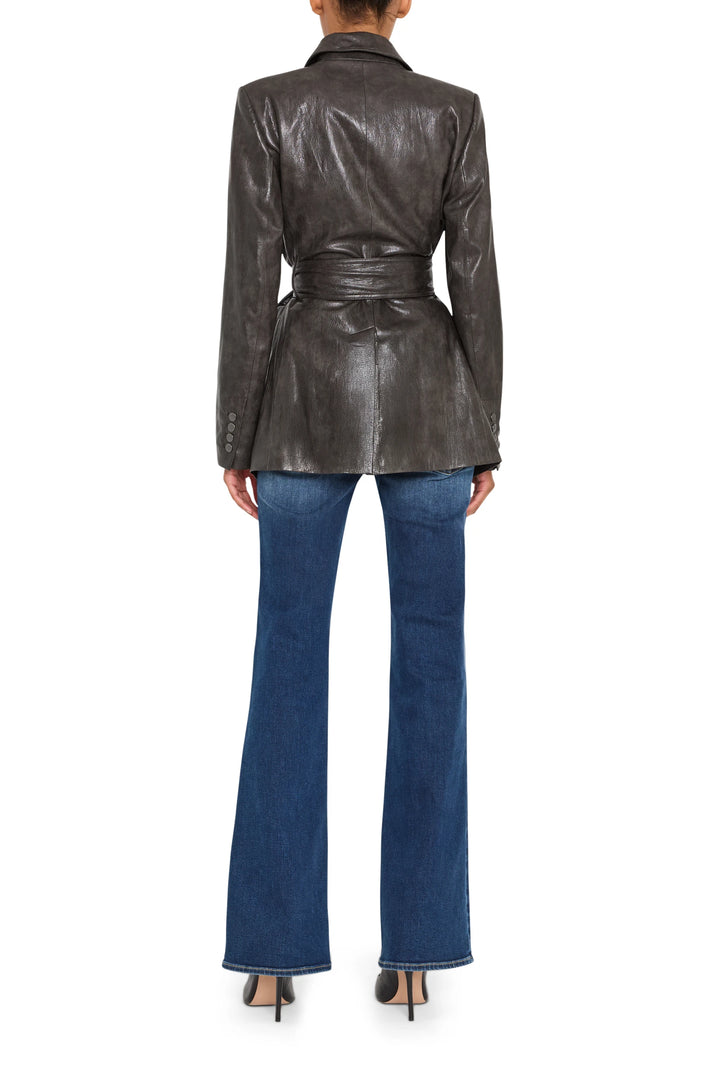 Vegan leather jacket, structured silhouette with classic collar and panel seams, back view on model.