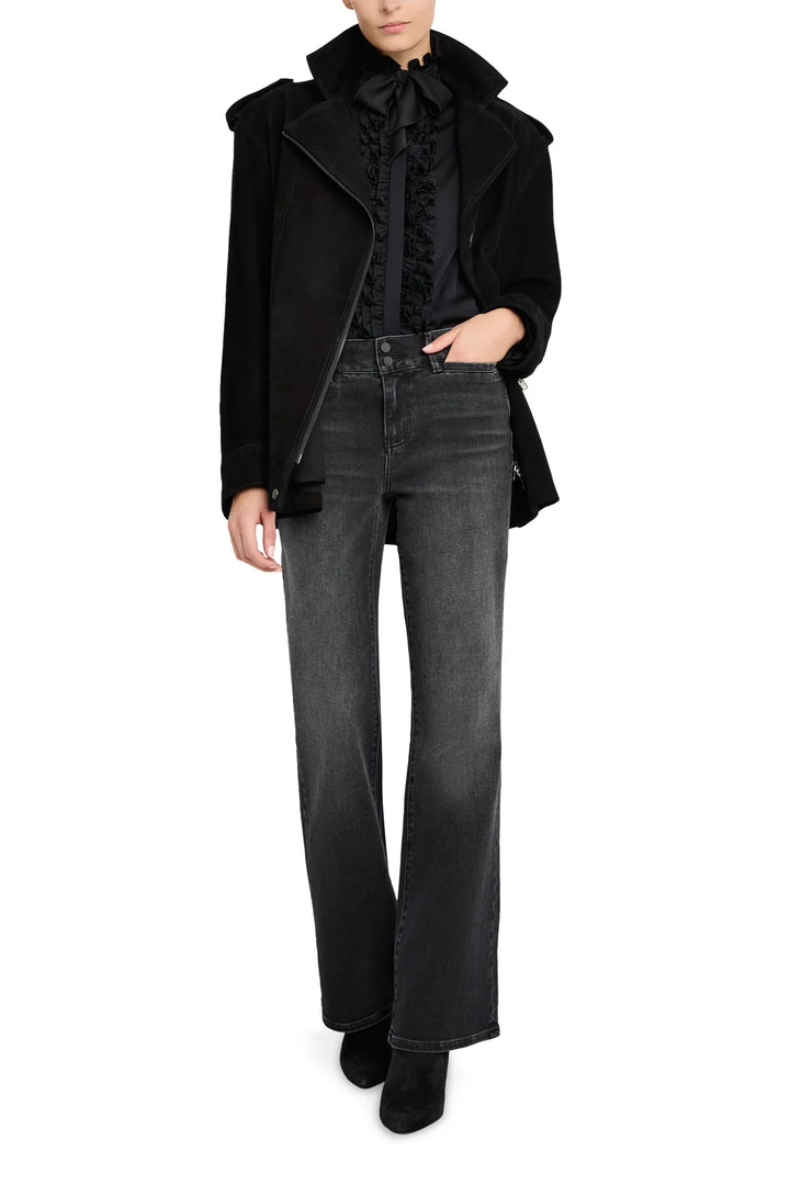 Tailored moto jacket with notch lapels, zip closure, and suede finish; front view on model.