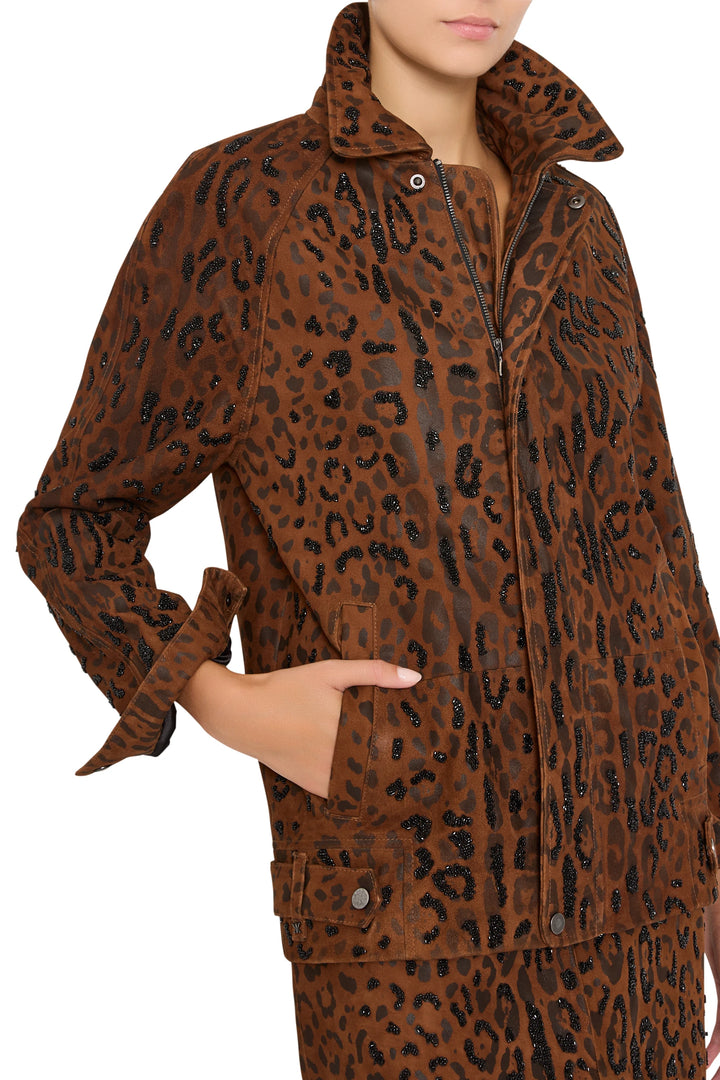 Suede jacket with collar up, black sequins, front pockets, structured silhouette. Front view on model.