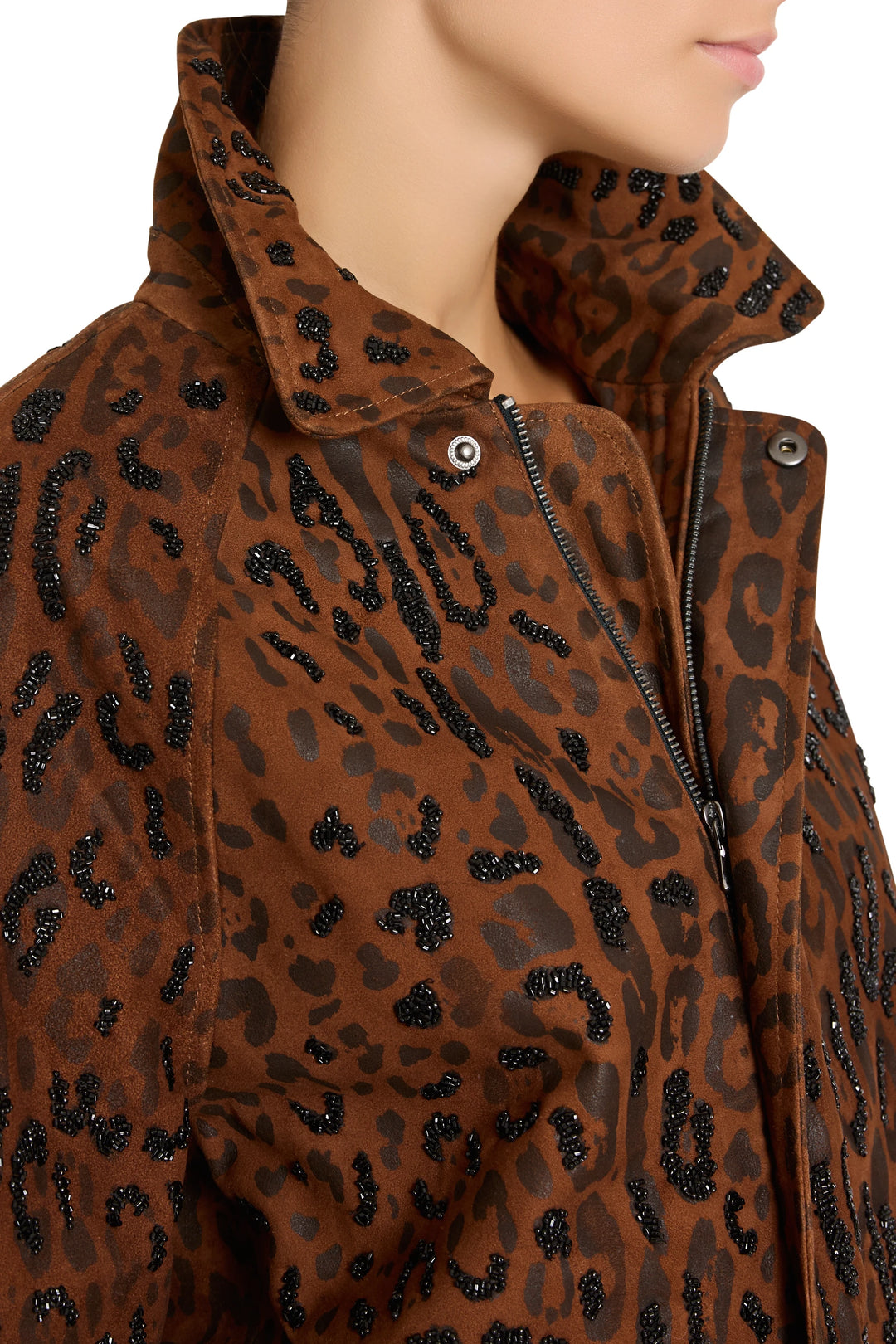 Tailored suede jacket with high collar, black beaded accents, and embroidery; front view on model.