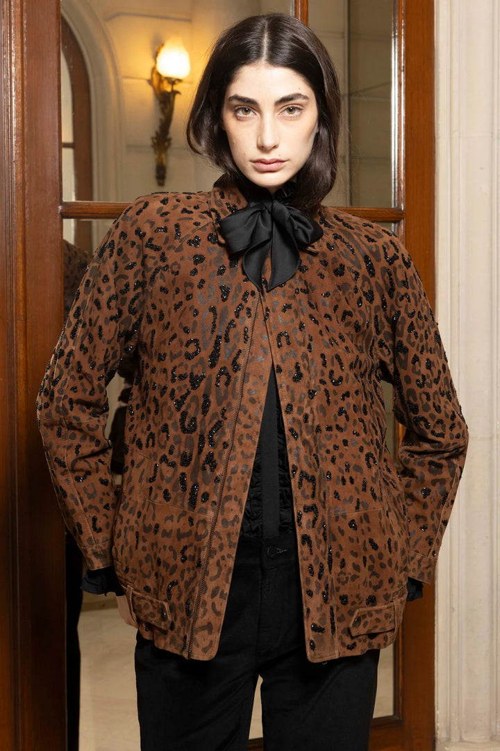 Relaxed-fit suede jacket with notch collar, front pockets, and button closure; front view on model.