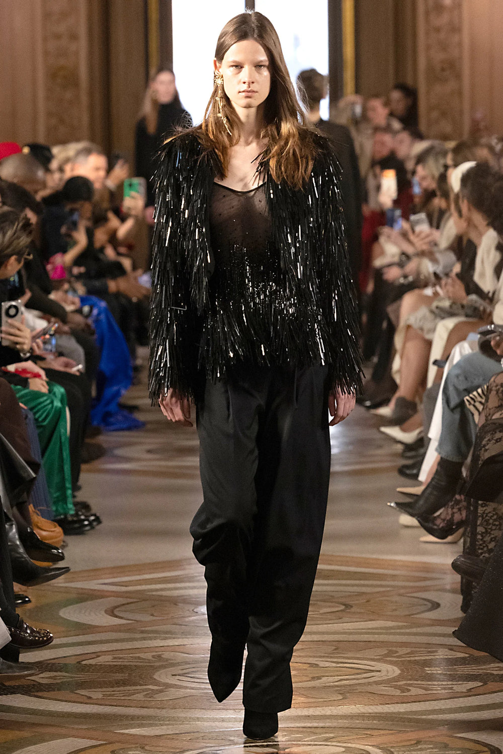 Sleeveless blouse with embellished front, relaxed fit, and round neckline. Front view on model.
