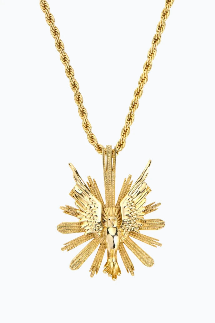 Gold pendant with eagle in flight and radiant rays, detailed rope chain; front view on white.