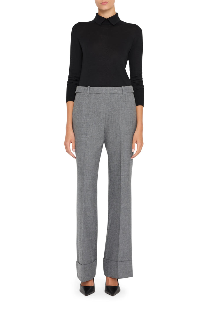 Wide-leg, dramatic gray trousers with wide cuffs in soft flannel; tailored waistband, front view on model.