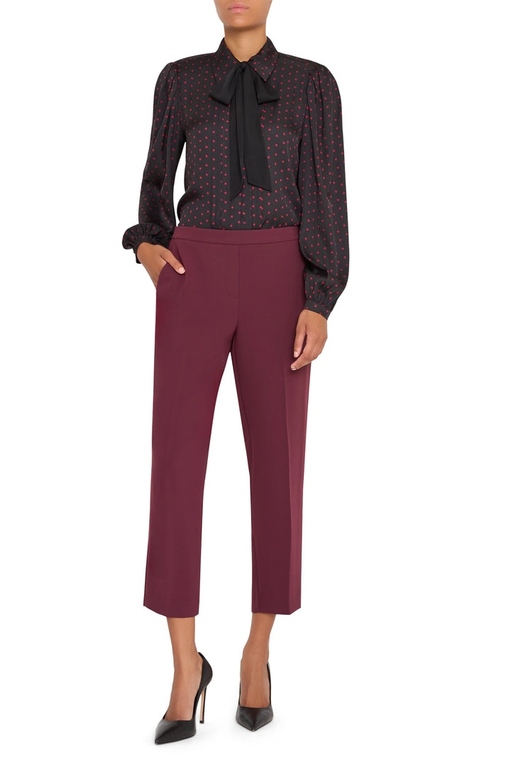 Slim ankle-length crepe pant with elastic pull-on waist and clean front, fluid silhouette; front view on model.