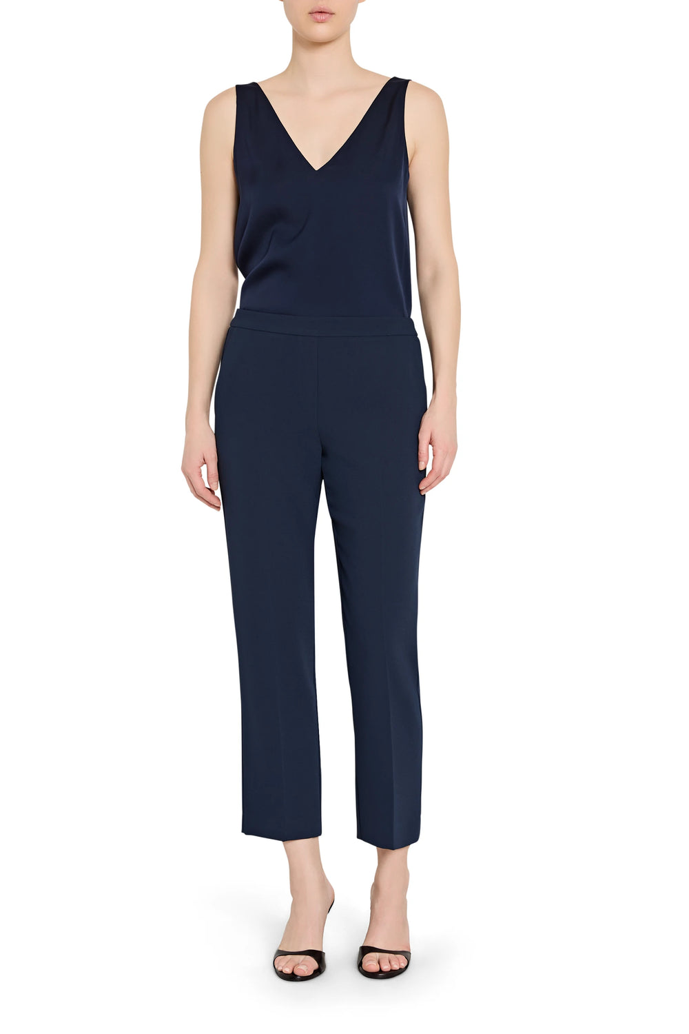 Slim, ankle-length pull-on crepe pant with clean waistband and tapered leg; front view on model.