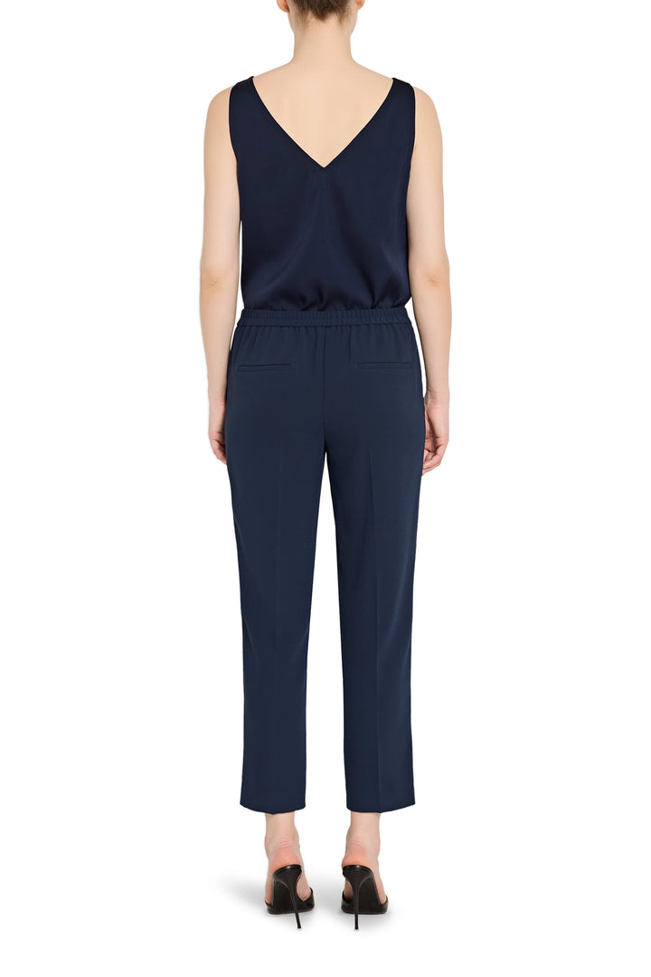 Slim, ankle-length crepe pant with pull-on waistband and clean lines, straight silhouette; back view on model.
