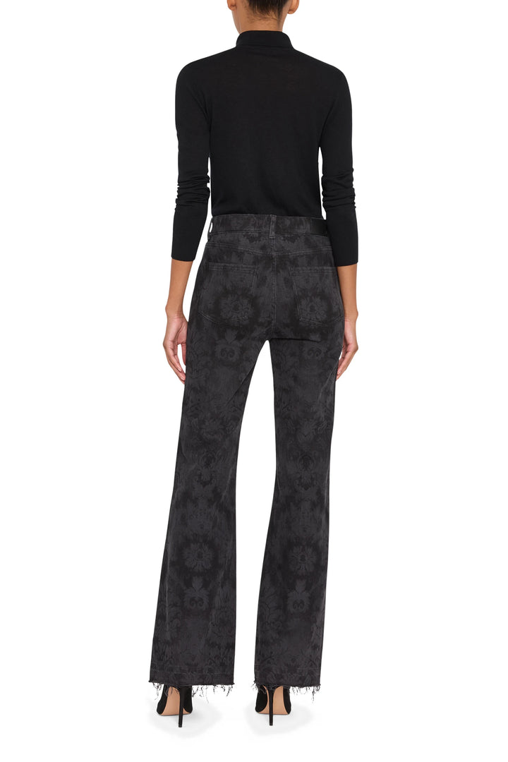 Wide-leg silhouette, printed fabric, classic five-pocket construction; back view on model.