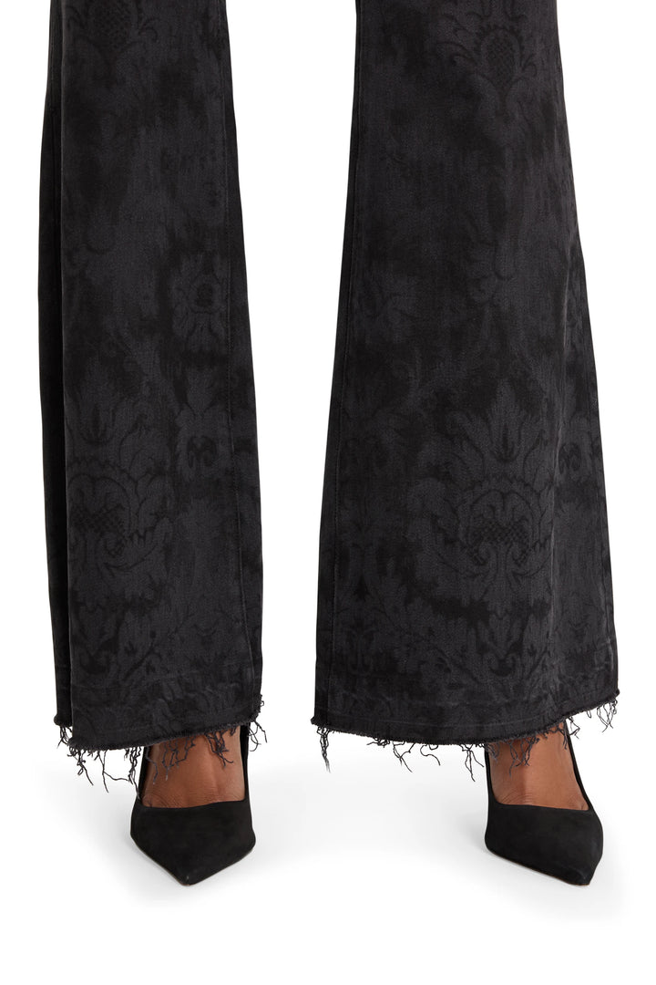 Pointed-toe heel with sleek construction and low vamp; streamlined silhouette, side view on model.