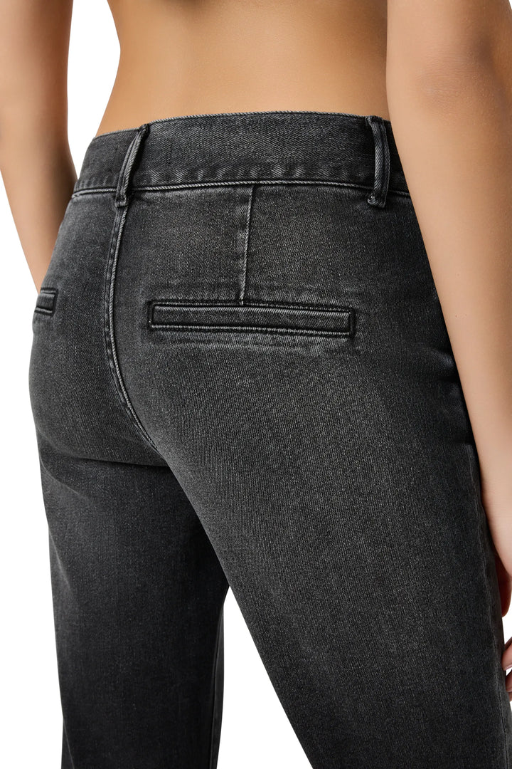 High-waisted slim denim with structured waistband, classic five-pocket design; back view on model.