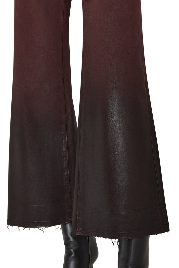 Cropped coated jean with raw hems, slim silhouette, and structured construction. Front view on model.