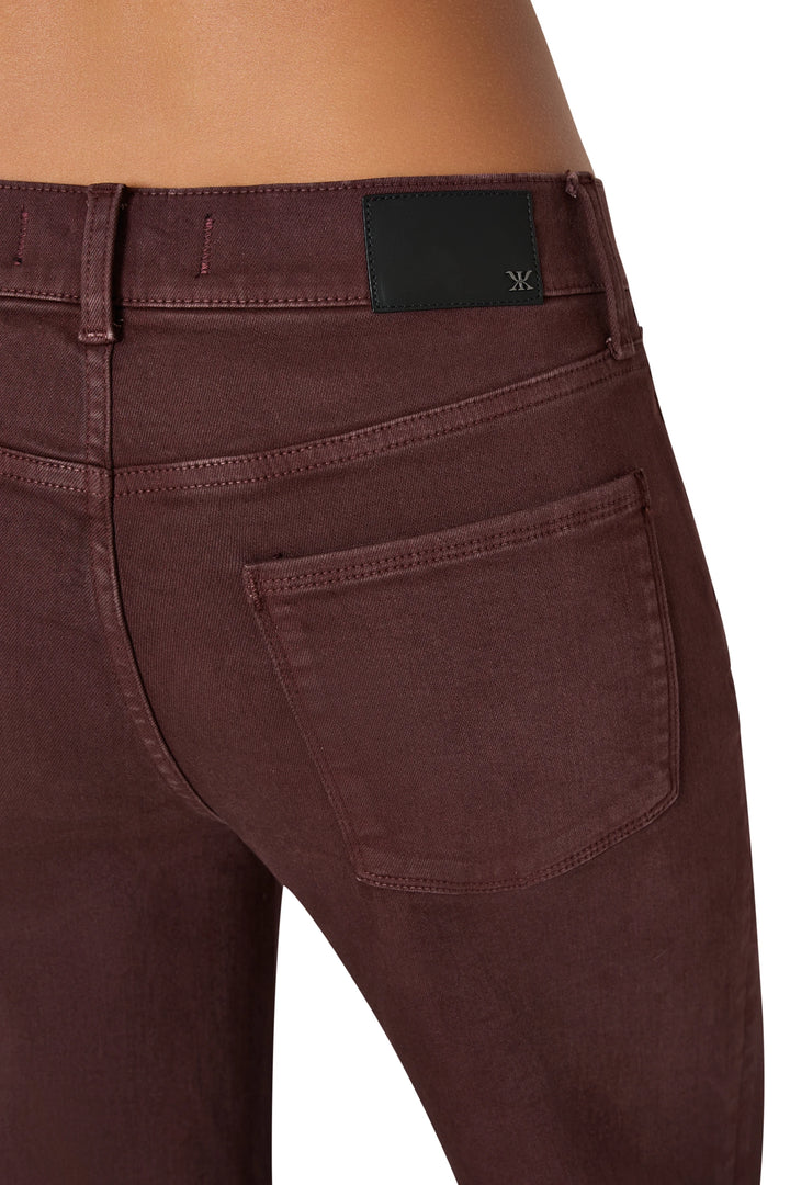 Detail of coated stretch cotton, waistband, and back pocket construction; black label at waist—detail view.