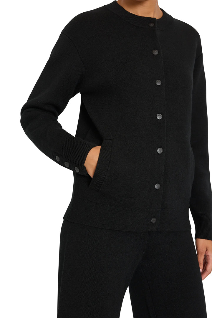 Relaxed-fit knit cardigan with soft drape, button front, ribbed cuffs and hem; front view on model.