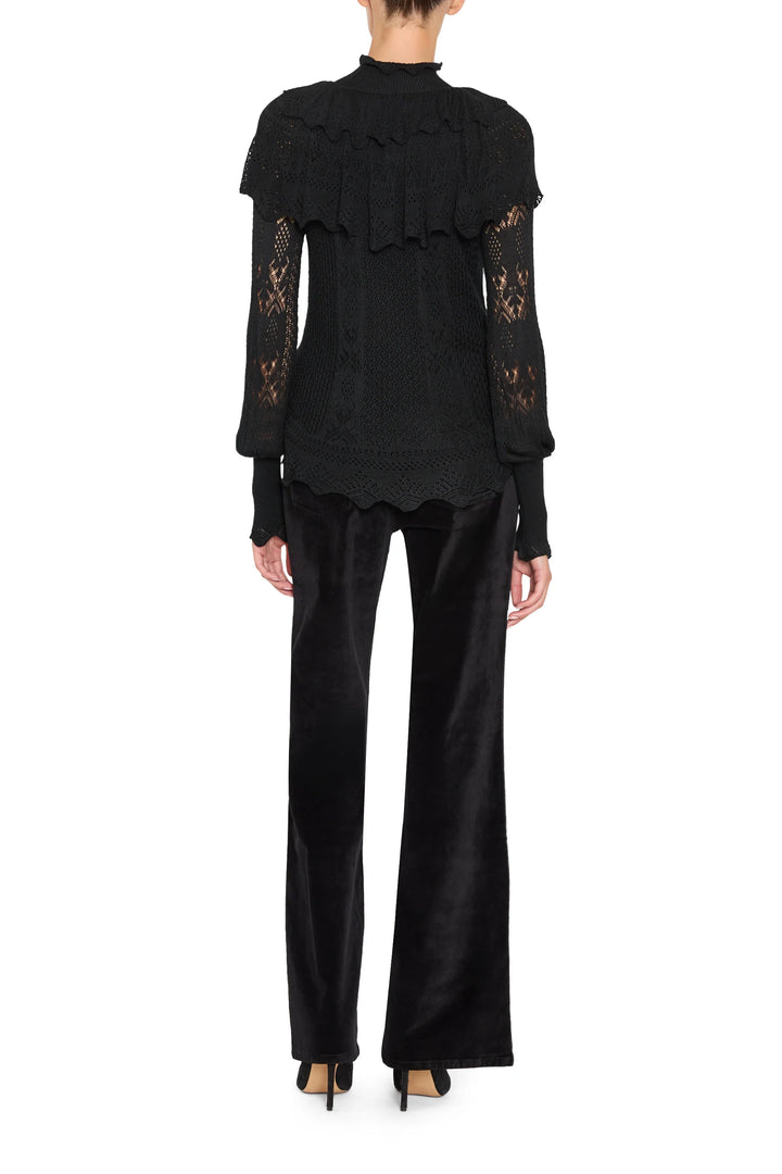 Black Justina Ruffle Sweater with a ruffled collar and Victorian lace sleeves, back view on white.