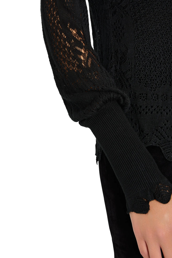 Justina Ruffle Sweater in black with lace-inspired stitching, bishop sleeves, and long ribbed cuffs, detail view.