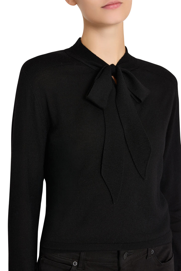 Black knit top with tie neckline, fitted silhouette, ribbed texture. Front view on white.