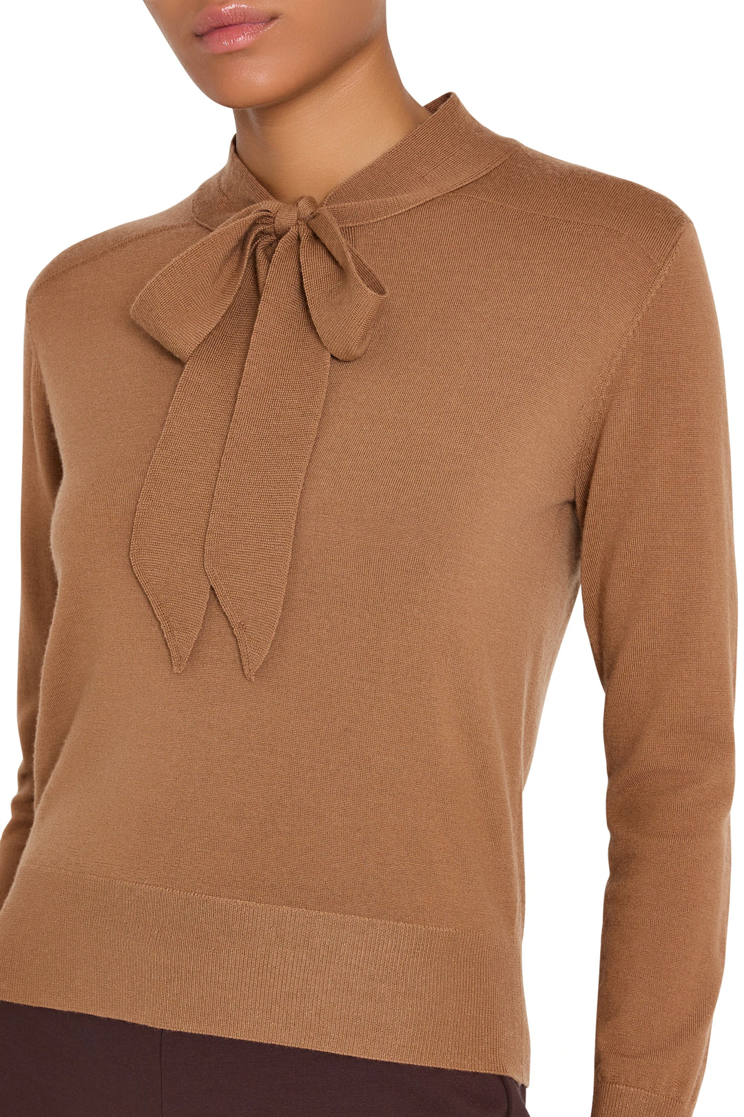 Cropped sweater with tie neckline, long sleeves, and ribbed hem in knit fabric; front view on model.