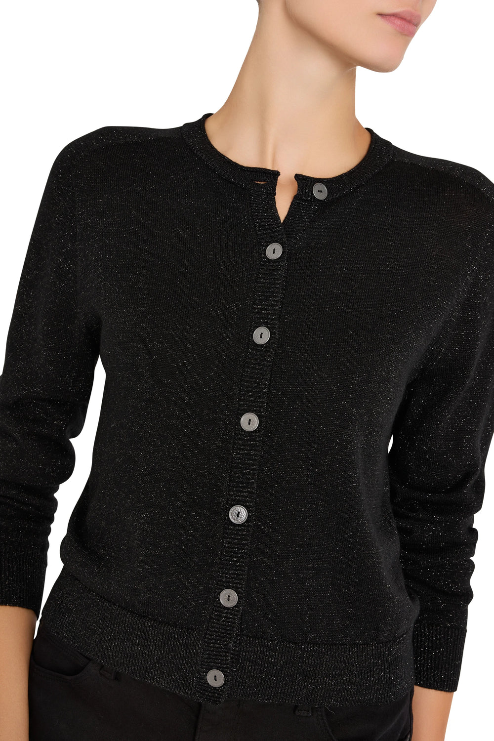 Cropped fine-gauge knit cardigan with long sleeves and round neck, fitted silhouette; front view on model.