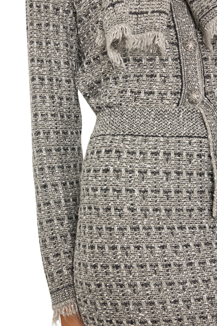 Textured knit with button detail and frayed hem of Juliette Tweed Sweater Skirt, detail view.