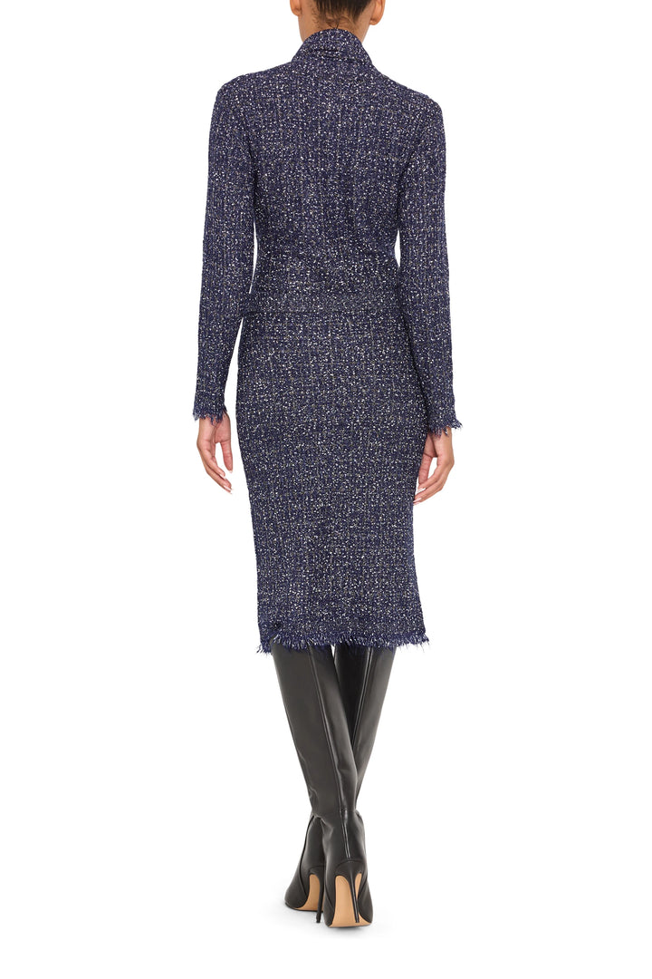 Straight, above-the-knee tweed skirt with subtle texture and fitted waistband; back view on model.