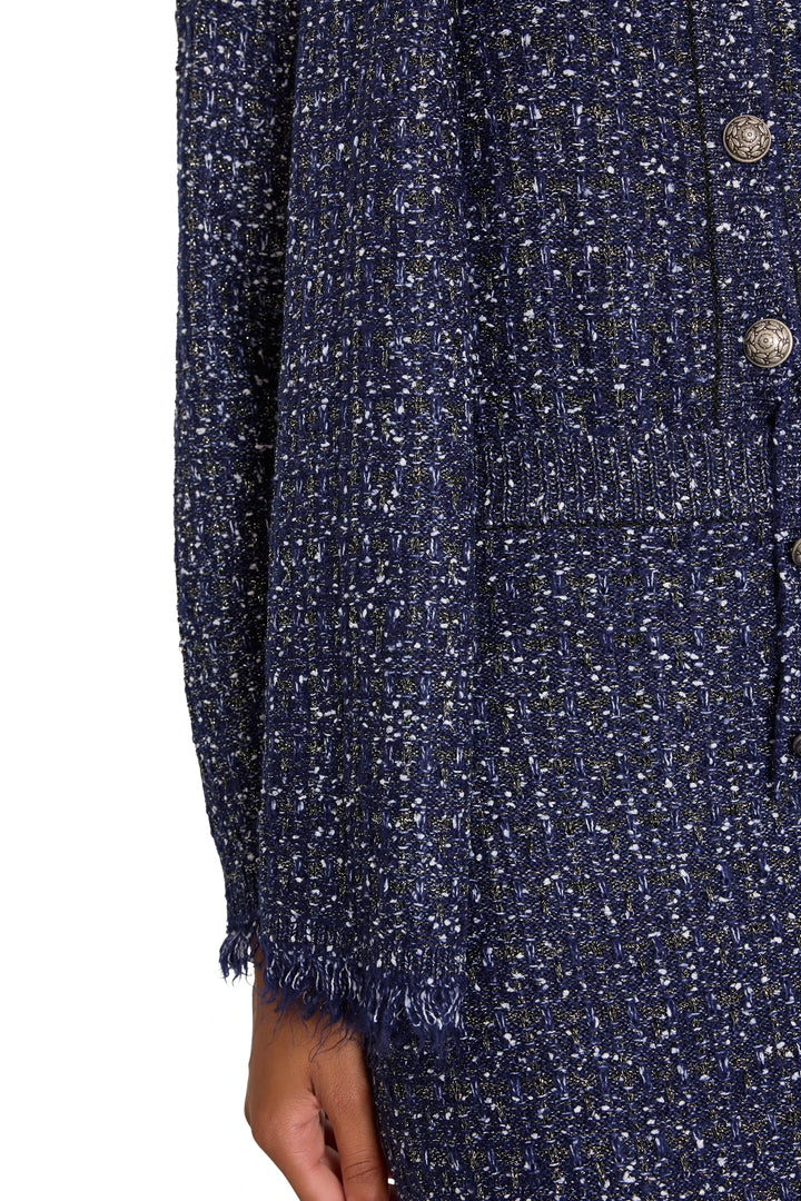 Straight, tailored tweed mini skirt with clean seams and structured waist; front view on model.