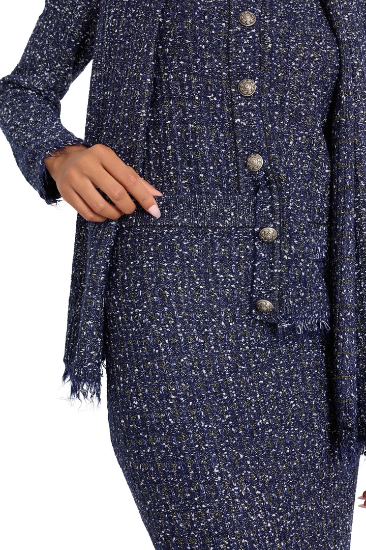 Tailored tweed sweater skirt with metallic buttons, straight silhouette, structured knit; front view on white.
