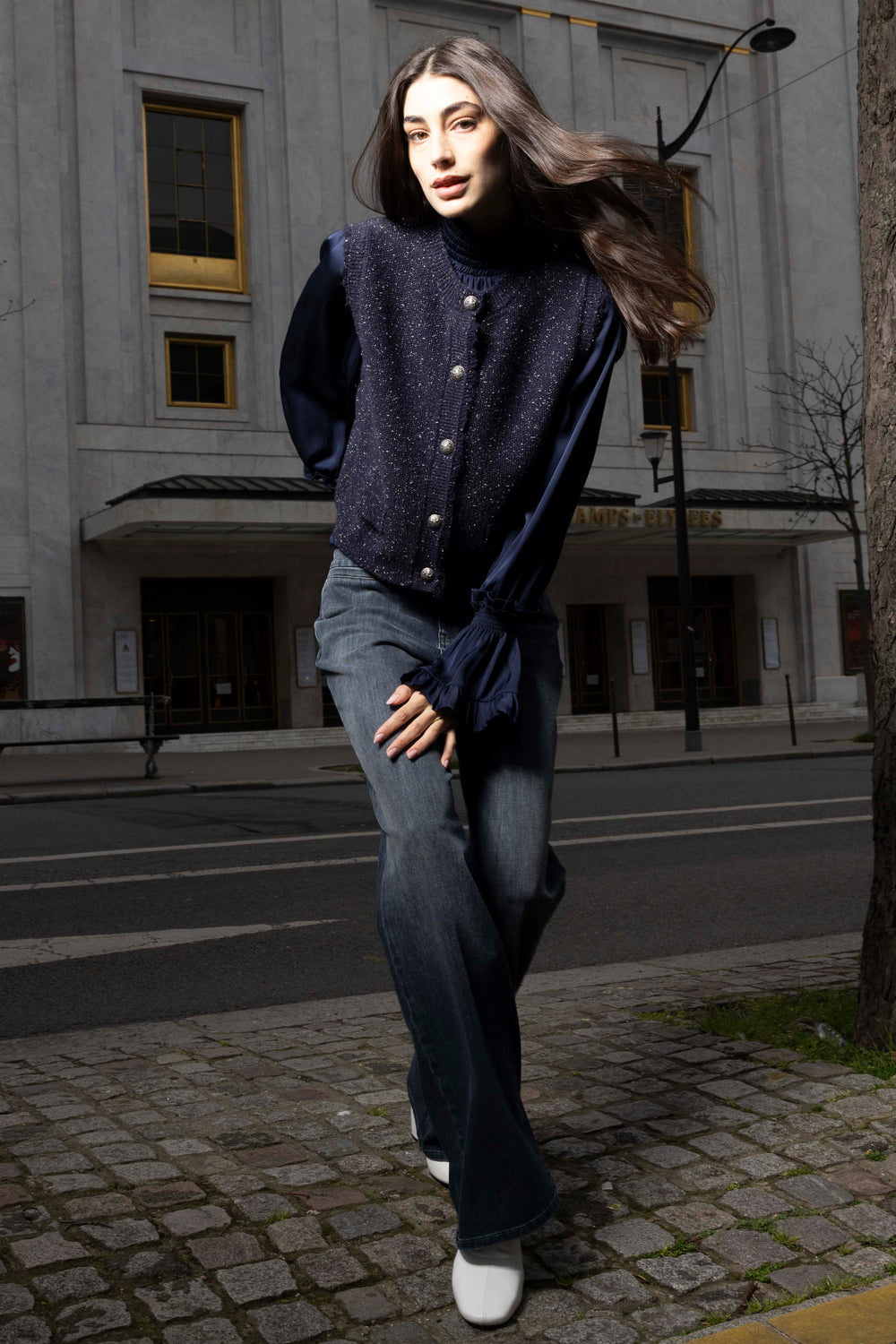 Sleeveless, relaxed-fit knit sweater vest with ribbed trim and classic crew neckline; front view on model.