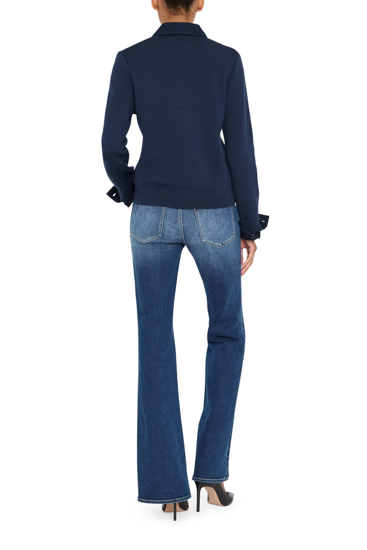 Relaxed fit cotton sweater with denim paneling and ribbed cuffs, hem, and neckline; back view on model.