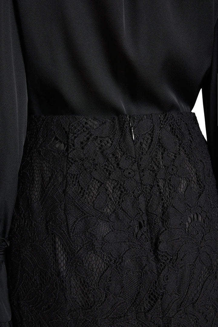 Close-up of the Simone Lace Skirt in black Italian corded lace, showing the back zipper detail view.