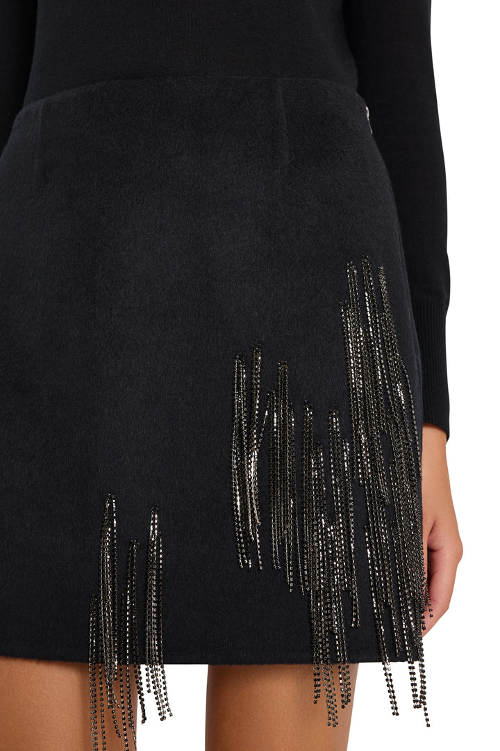 Mini skirt with bead fringe, fitted silhouette, embellished wool blend fabric. Front view on model.