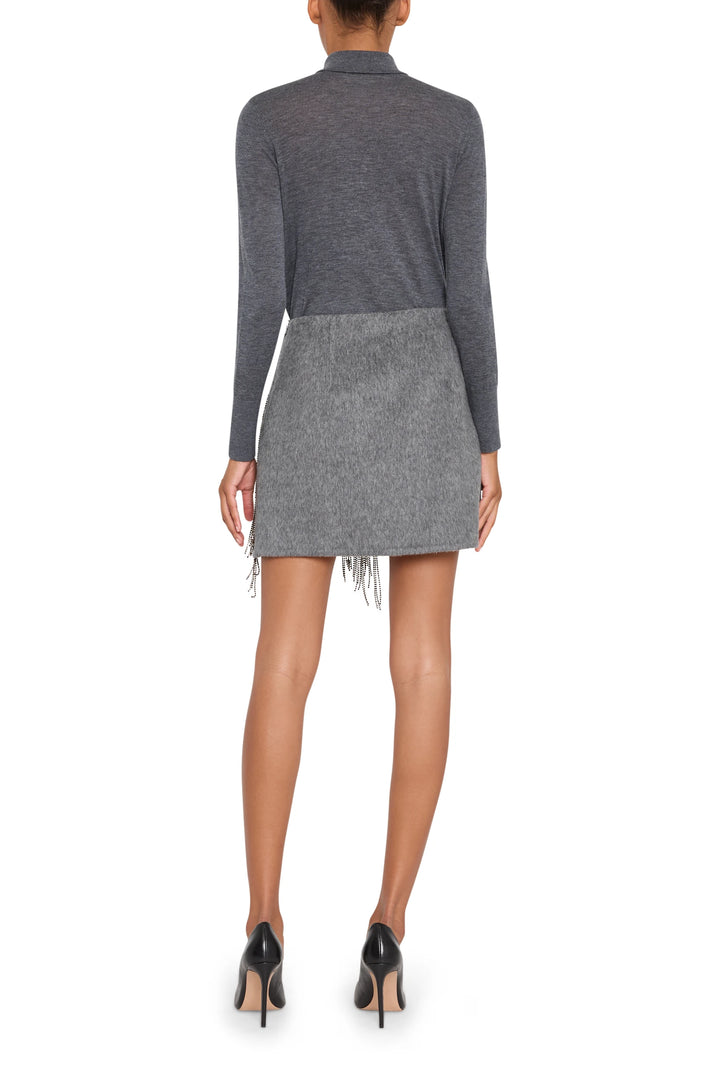 Mini skirt with embellished wool blend fabric, fitted silhouette, straight hem; back view on model.