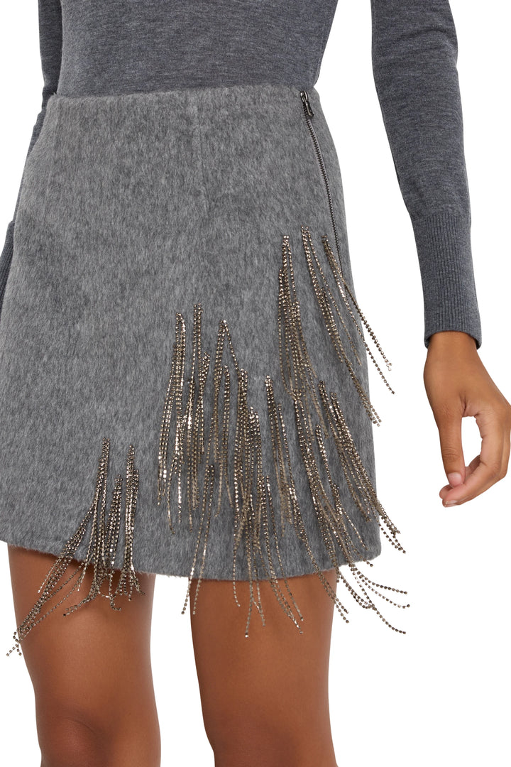 Mini skirt with metallic fringe embellishment, tailored wool blend construction. Front view on white.