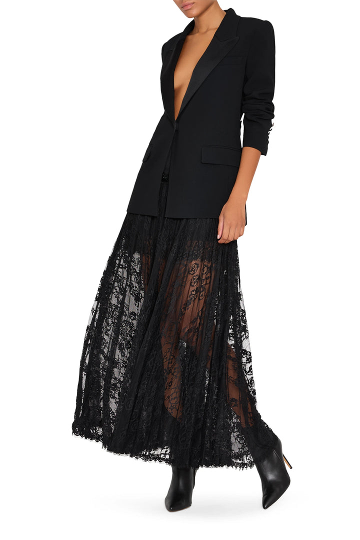 Long lace skirt with satin yoke waistband, fluid silhouette, delicate lace overlay; front view on model.