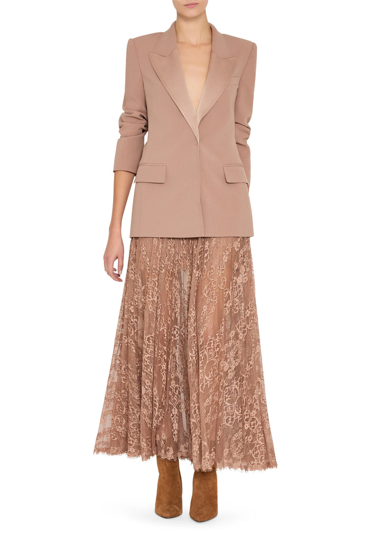 Long, fluid midi skirt with Chantilly lace overlay and delicate construction. Front view on white.
