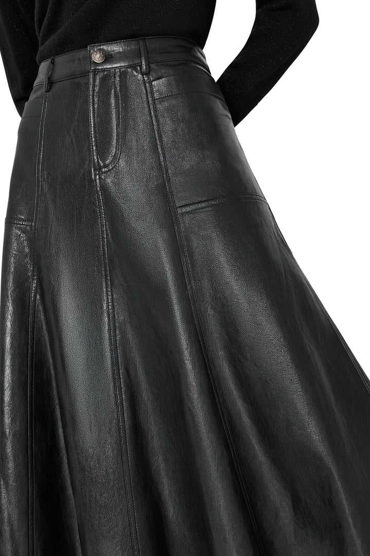 Vegan leather skirt with sleek midi silhouette, paneled construction. Front view on white.