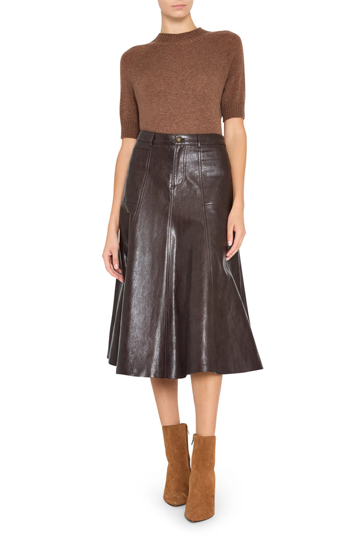 Vegan leather skirt with a straight silhouette, paneled construction. Front view on model.