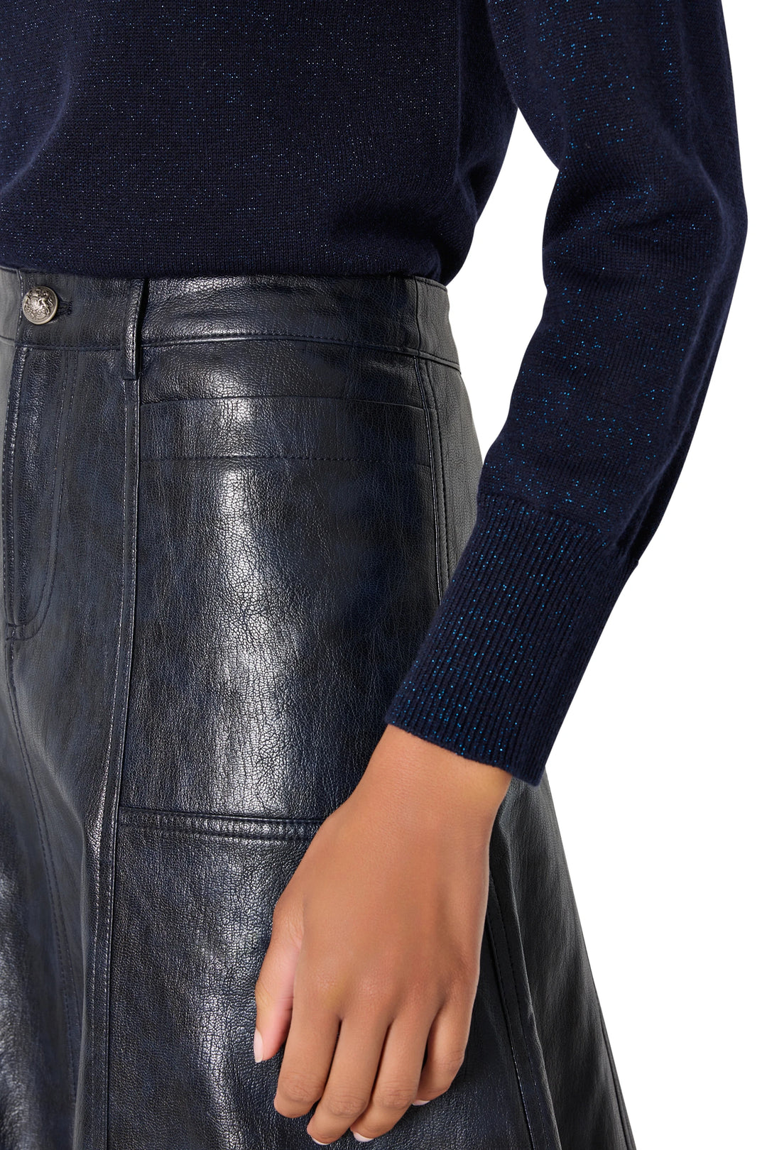 The Ellen Vegan Leather Skirt has a straight mini silhouette with clean lines and subtle seam detailing, front view on model.
