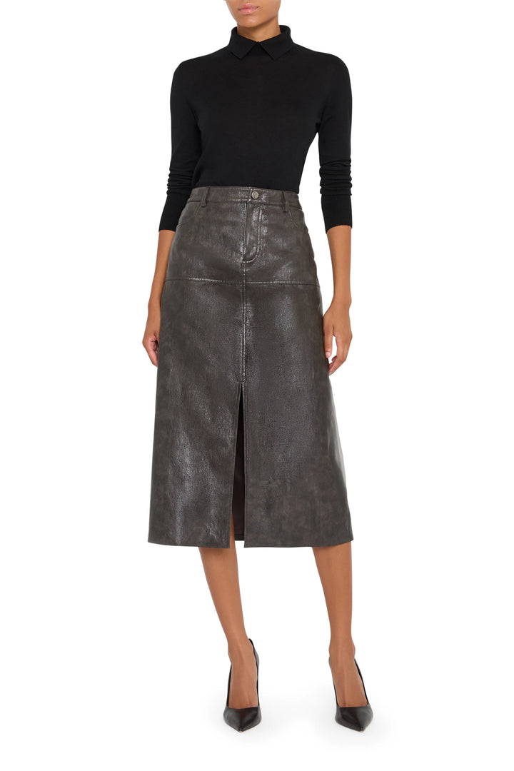 Fitted vegan leather pencil skirt with front slit and clean waistband, knee length, front view on model.