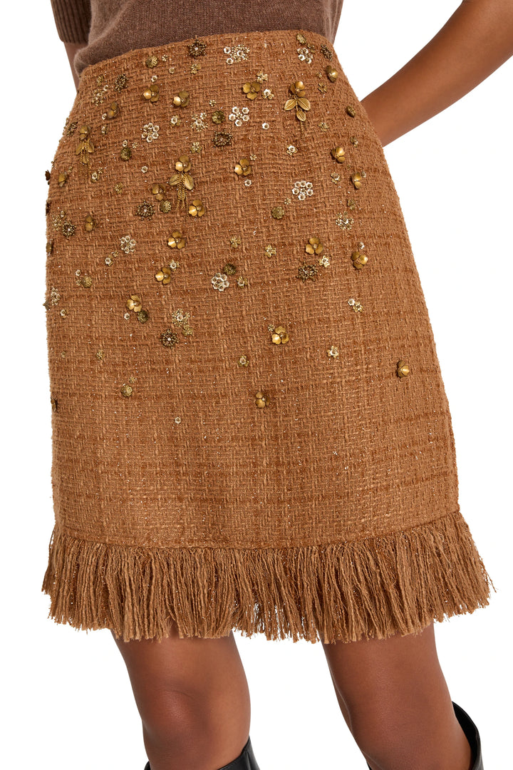 A-line tweed skirt with gold sequin floral accents, fringe hem; front view on model.