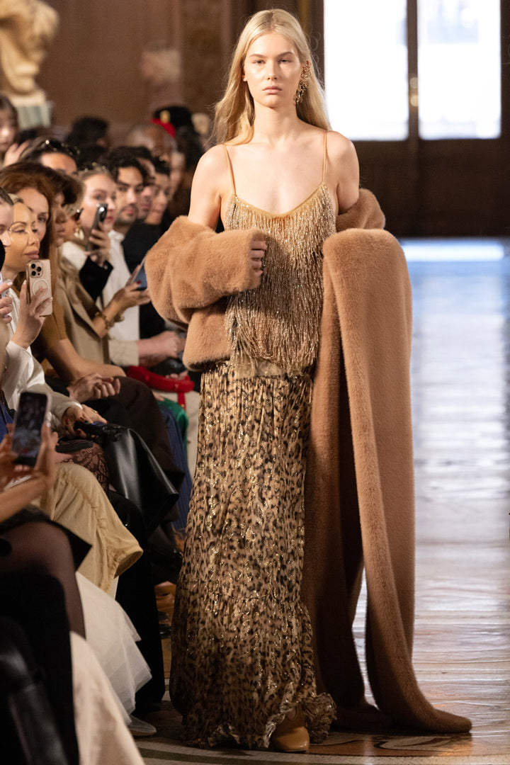 The Shona Long Lurex Skirt features a fluid silhouette with subtle shimmer, midi length; front view on model.