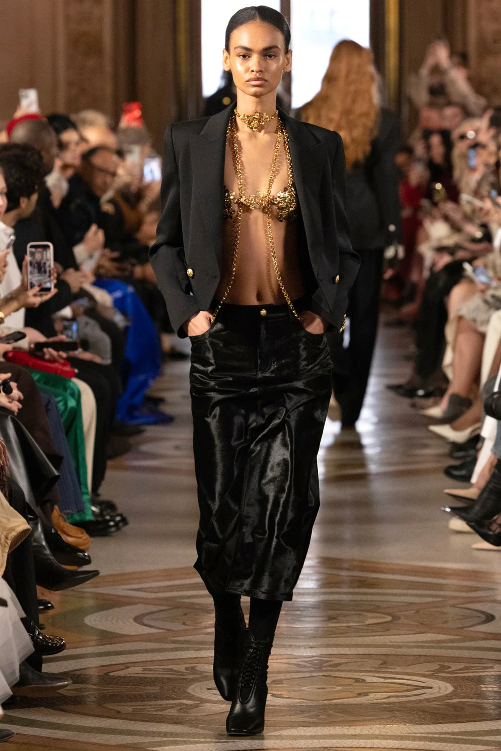 Mini skirt with tiered ponyhair panels, slim fit silhouette, exposed seams; front view on model.