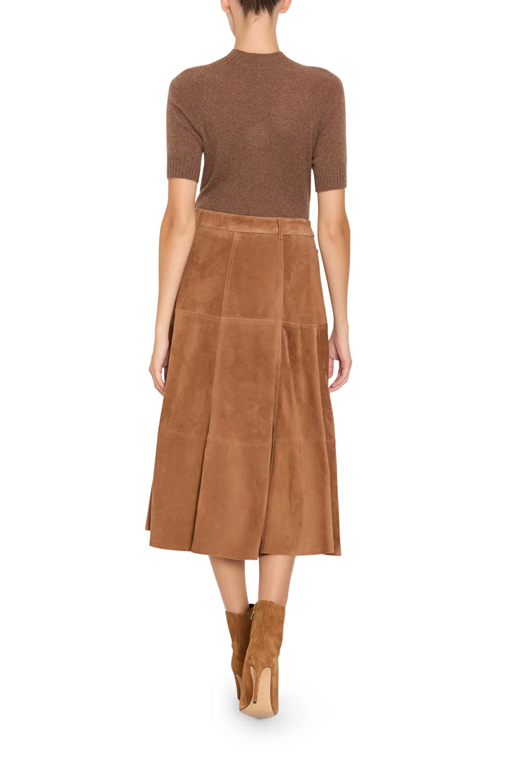 A-line suede skirt with paneled construction and front seam detail, mid-length silhouette, back view on model.