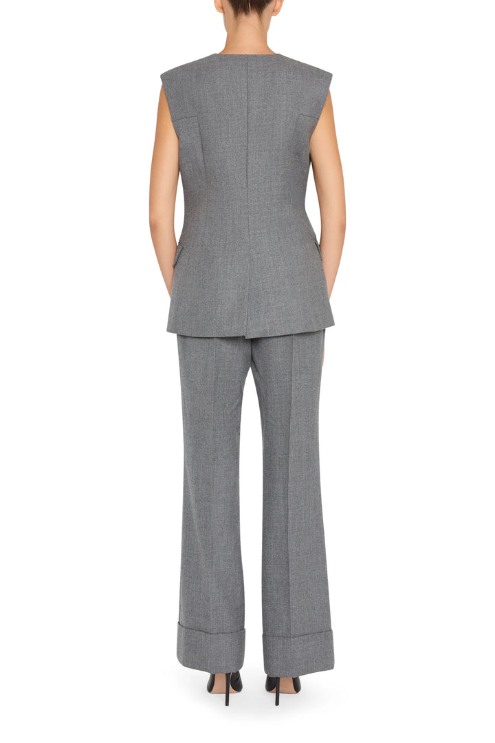 Sleeveless flannel vest with clean lines and button front, straight silhouette; back view on model.