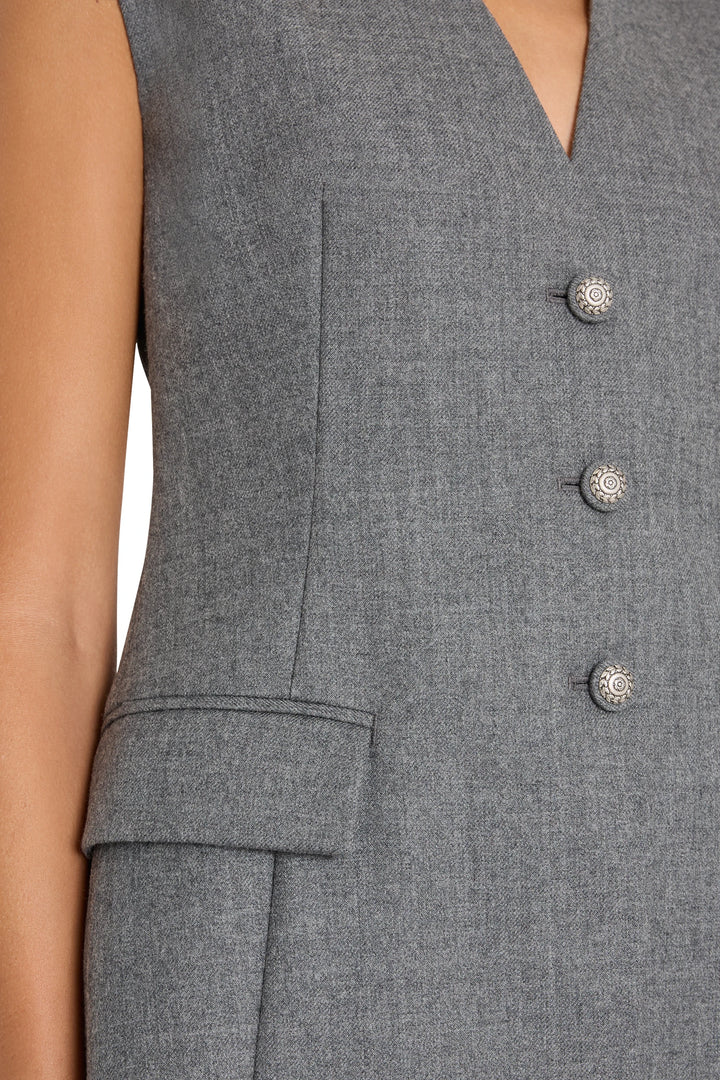 Sleeveless tailored dress with silver buttons and pocket flap detail, structured fit; front view on model.