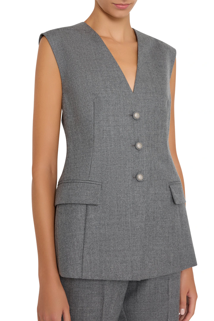 Sleeveless, tailored flannel vest with three buttons and minimal detailing. Front view on model.