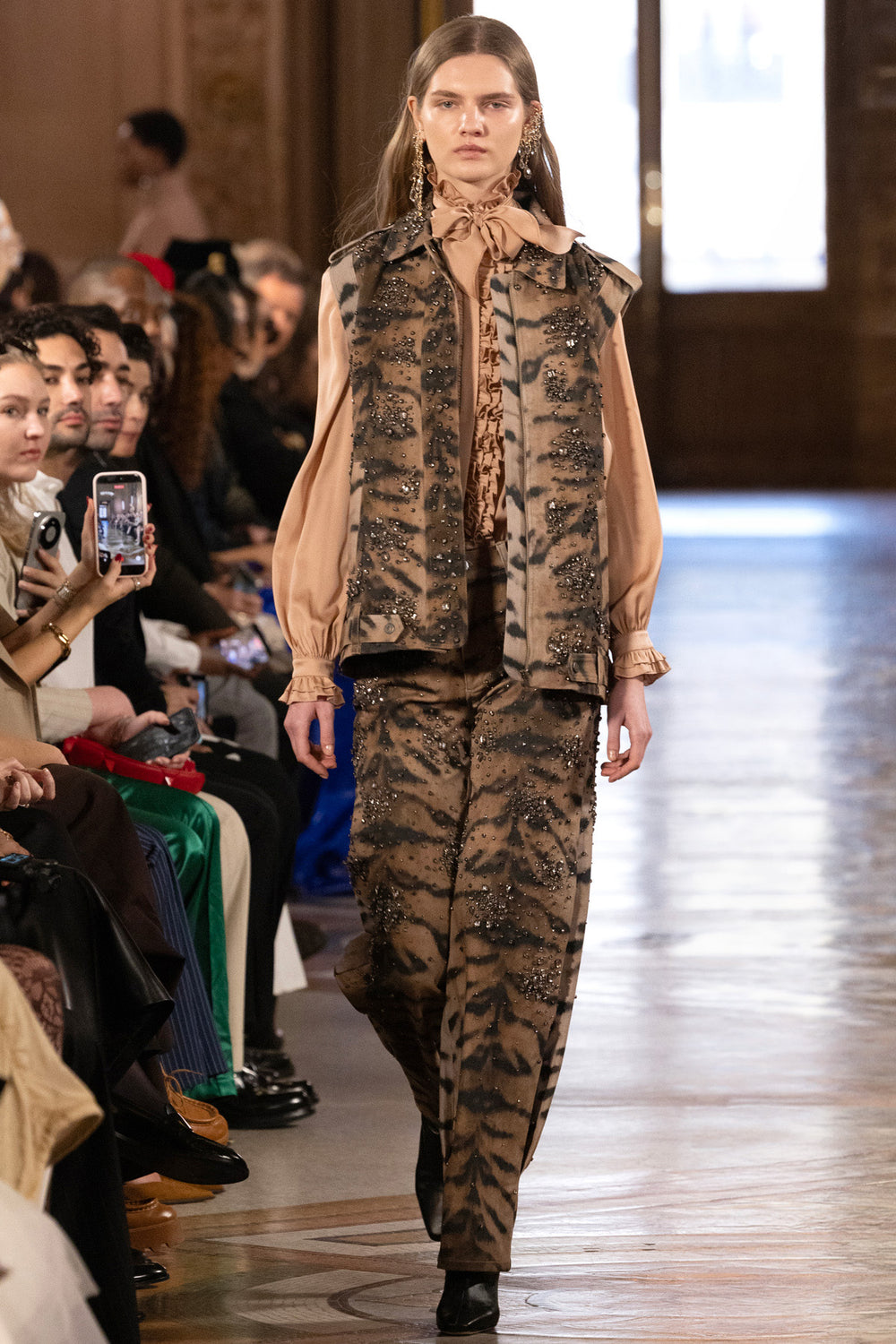 Wide-leg denim pant with tiger motif, animal print, and embellished details; front view on model.