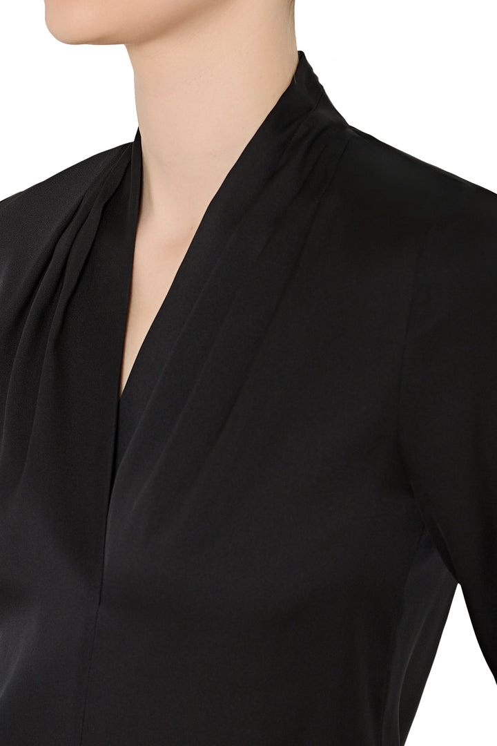Black blouse with a deep neckline on a mannequin against a white background